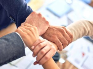 hands in a square of a charity team